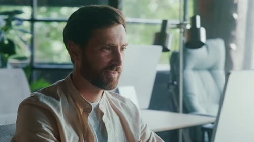 Dedicated and Focused Professional Excelling With SelfSatisfied Smile in a Modern Office Environment