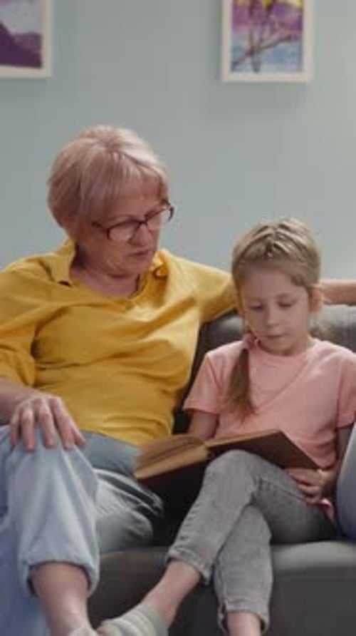 Grandmother and Child Reading a Book Together