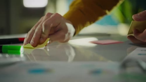 Close Up Hands Put Sticky Notes On White Board