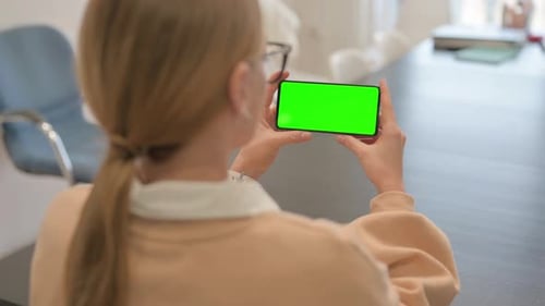Woman Holding Phone with Green Screen
