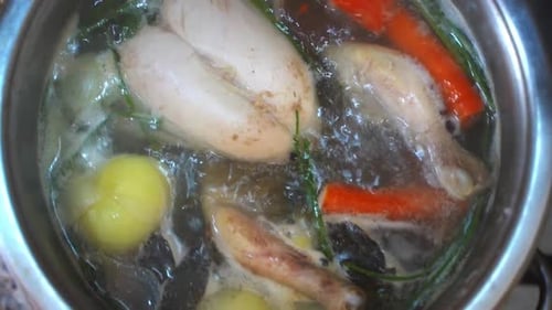 Cooking Chicken Broth on the Stove in the Kitchen
