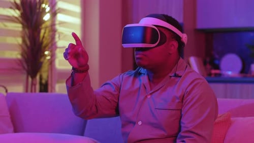 Man Wearing VR Headset Interacting with Virtual Reality