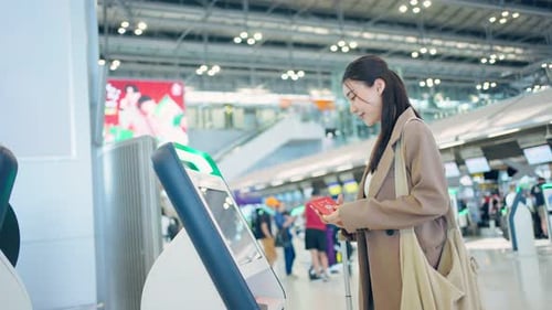 Asian young woman passenger check in at counter in the airport terminal.