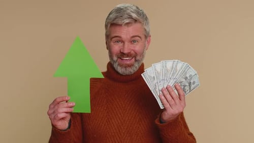 Man Holding Cash and Up Arrow Smiling