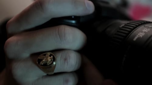 Close Up of Hands Holding DSLR Camera