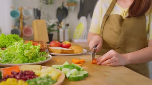 Close up of woman cooking healthy foods in kitchen in morning at home.