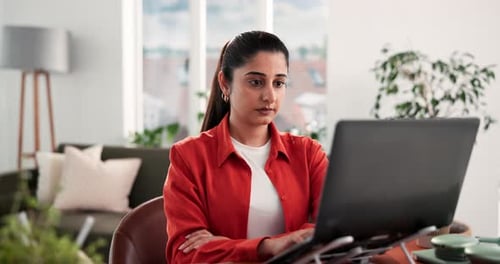 Woman Working on Laptop in Bright Home Office