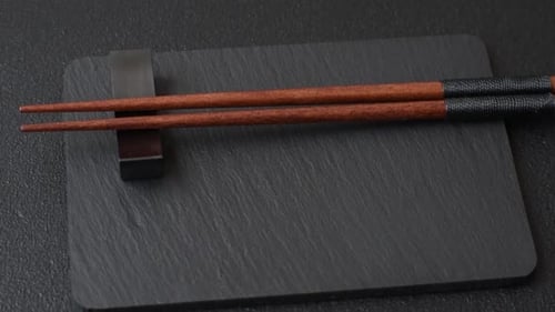 Wooden bamboo chopsticks for sushi and other Asian food with a blank background. Wooden chopsticks