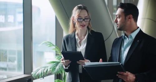 Coworkers reviewing reports together in office