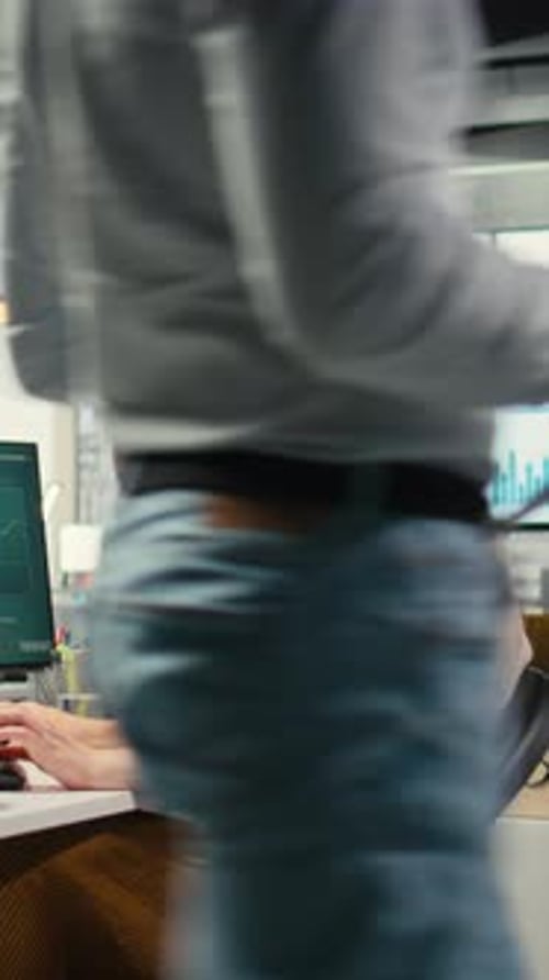 Vertical Video Female Executive Consultant Listening to Songs on Headphones at the Workstation