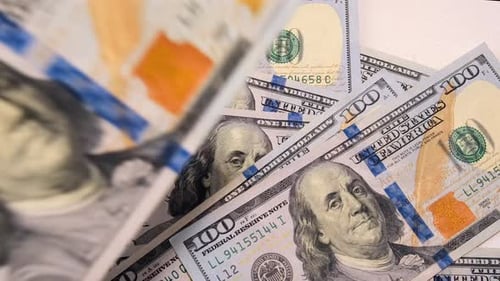 Hundred dollar bills fall on the table. American 100 dollar banknotes. Us national paper currency.