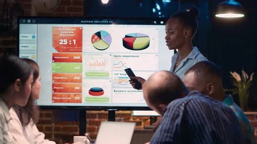 Diverse Team Discusses Business Analytics in Modern Office