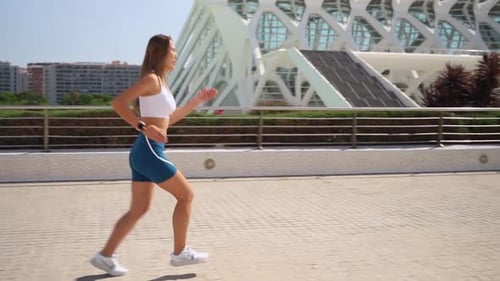 Woman Jogging on Sunny Urban Cityscape