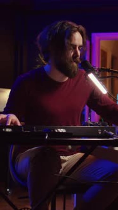 Musician Plays Keyboard in Music Studio