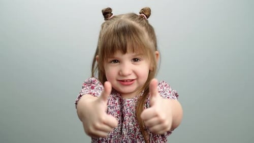 Smiling Girl Gives Thumbs Up Approval