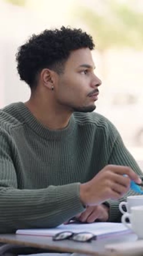 Young Black Male Student Brainstorming Ideas Outdoors at University Campus Vertical