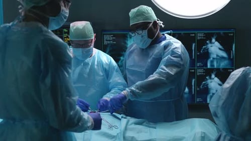 Team of Professional Medical Surgeons Performs the Surgical Operation in a Modern Hospital Doctors