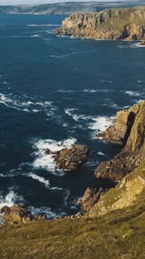 Waves crashing on the rocks of the coast Aerial view Vertical vide