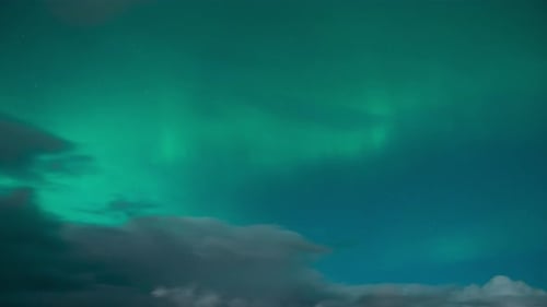 Time lapse of the aurora borealis (the northern lights) on a cloudy night. Filmed in the village of