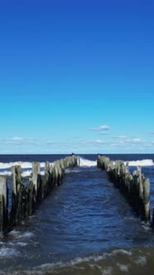 A wooden pier in the middle of a body of water
