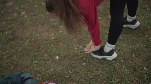 Young Woman Stretching Outdoors for Fitness Warmup
