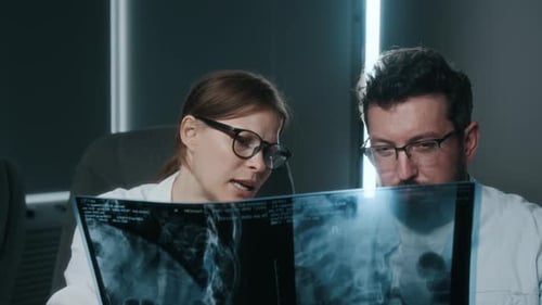Medical professionals analyzing x-ray in modern hospital room