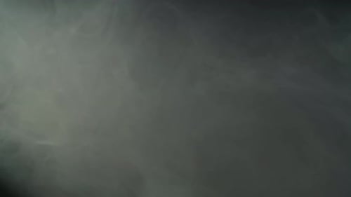 Dense Clubs of Gray Smoke Fog Illuminated By Spotlight in Studio on Black Background Texture Effect