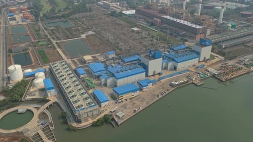 Aerial view of power plant and electrical substation by the river