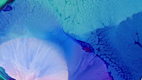 Vibrant blue ink spreading in water creating an abstract pattern