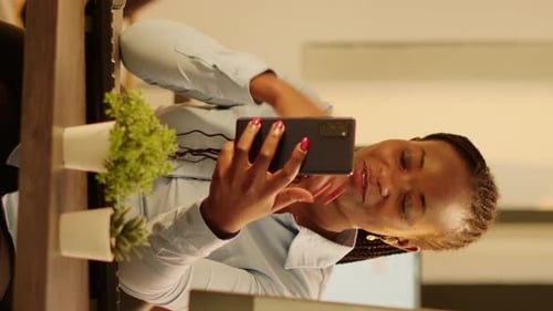 Enthusiastic Woman Video Conferencing in Modern Office