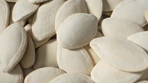 Macro video of pumpkin seeds.