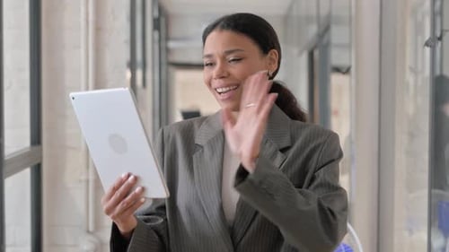 Professional Woman Using Tablet for a Video Conference
