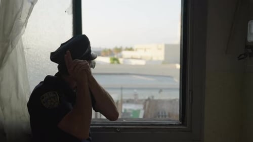 Police Officer Acting as Lookout in Urban Setting