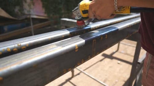 Metal Processing with Circular Saw Tool Hands of Mechanic Holding Special Instrument and Clearing