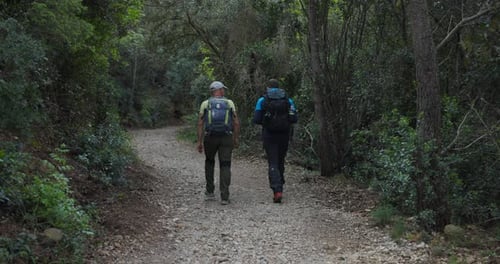Two Men With Backpacks Traveling Over Mountain Trails In Noli, Italy. Static Shot