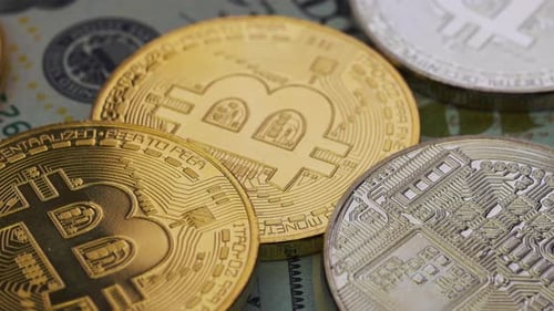 Bitcoin Cryptocurrency Golden and Silver Coins on Money