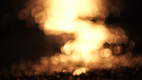 Blurred Golden Sea at Sunset The Sun Reflects and Sparkles on the Waves with Bokeh Illuminating the