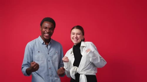Excited Man and Woman Celebrating Success Together