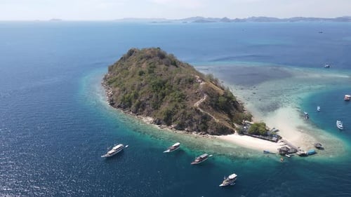 Aerial view of beaches and tourist boat sailing in Kelor Island, Flores Island, Indonesia.