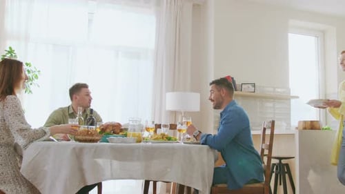 Young Adults Enjoying Pleasant Meal Together at Home