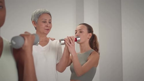 Smiling Women Working Out with Weights