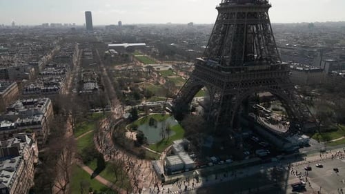 Champ de Mars between Tour Eiffel and Montparnasse Tower, Paris in France. Aerial backward