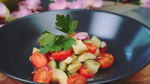Bright Vegetable Salad in a Black Bowl