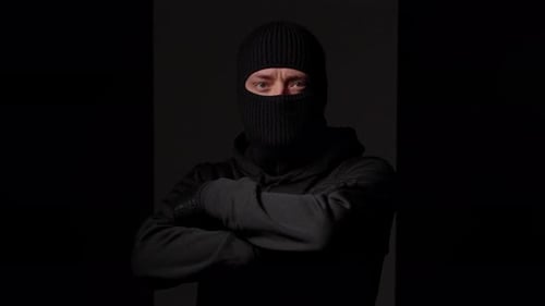 Hooded Person Wearing Knit Balaclava with Arms Crossed