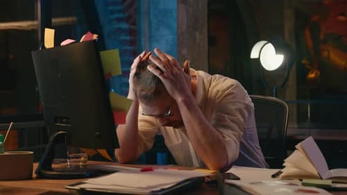 Stressed Business Man in Dark Night Office Holding Head Problem with Computer Exhausted Businessman