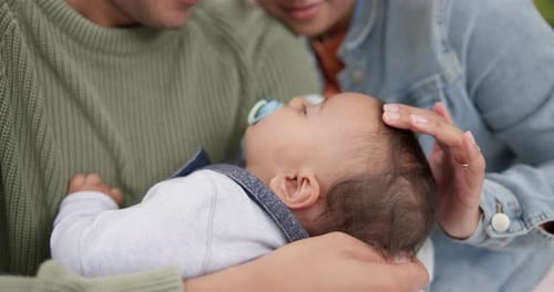 Infant Sleeping Peacefully in Loving Parents Arms