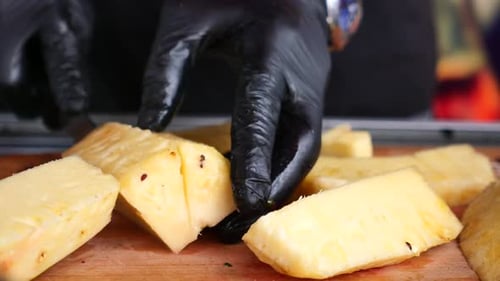 Chef cuts Fresh Pineapple on Cutting Board