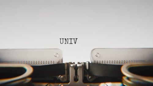 Old mechanical typewriter typing University in a close-up view.