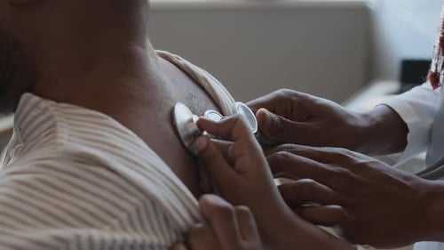 Doctor Examines Patient with Stethoscope in Clinic