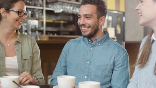 Group of Positive Mixed race Young People Having Conversation in Coffee Shop.